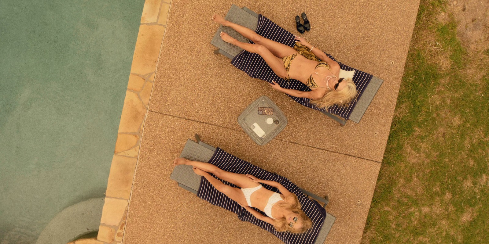 Angela Norris and Ainsley Norris pool outfits on Landman